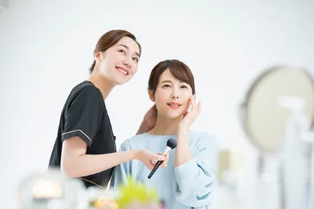 ヘアスタイルとメイクをする女性